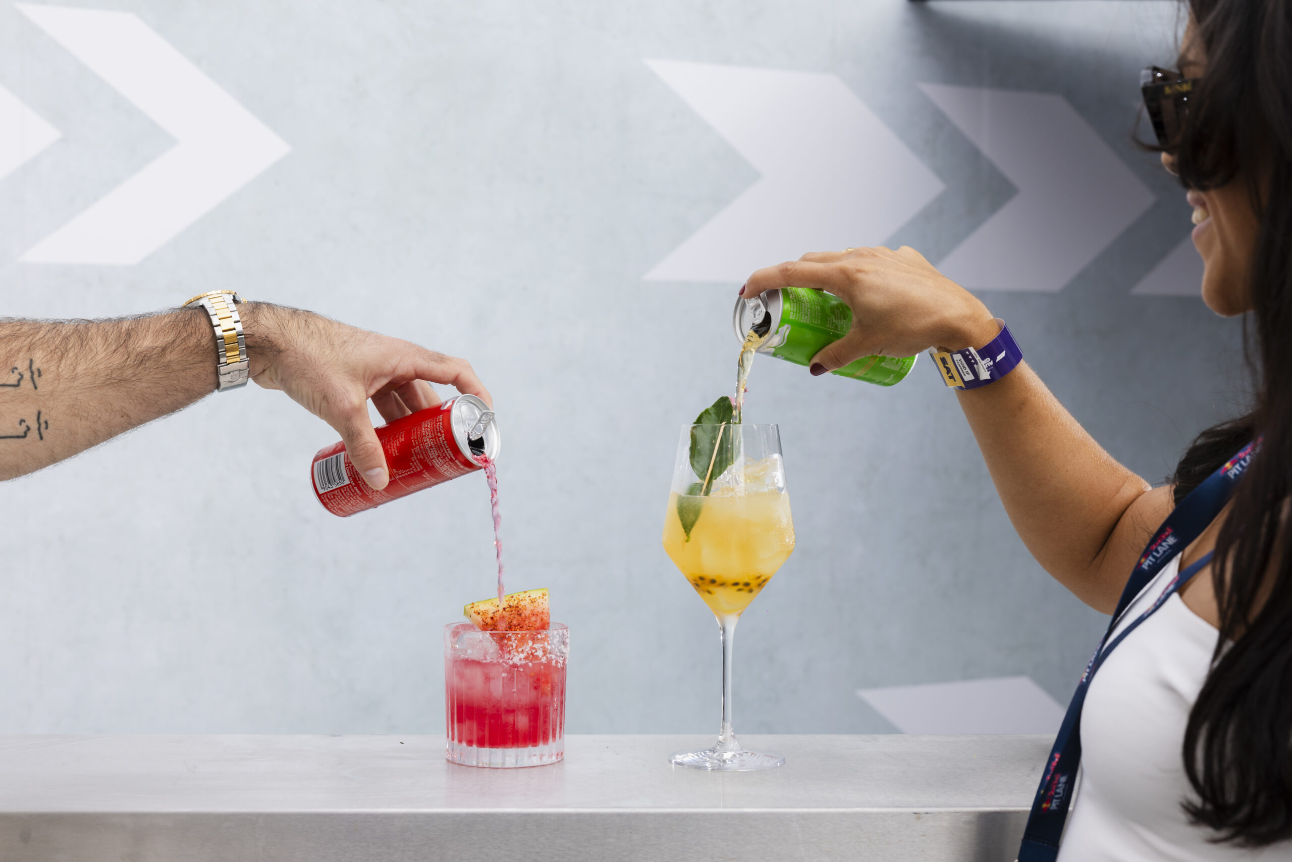 Guests pouring Red Bull cans in to cocktail glass