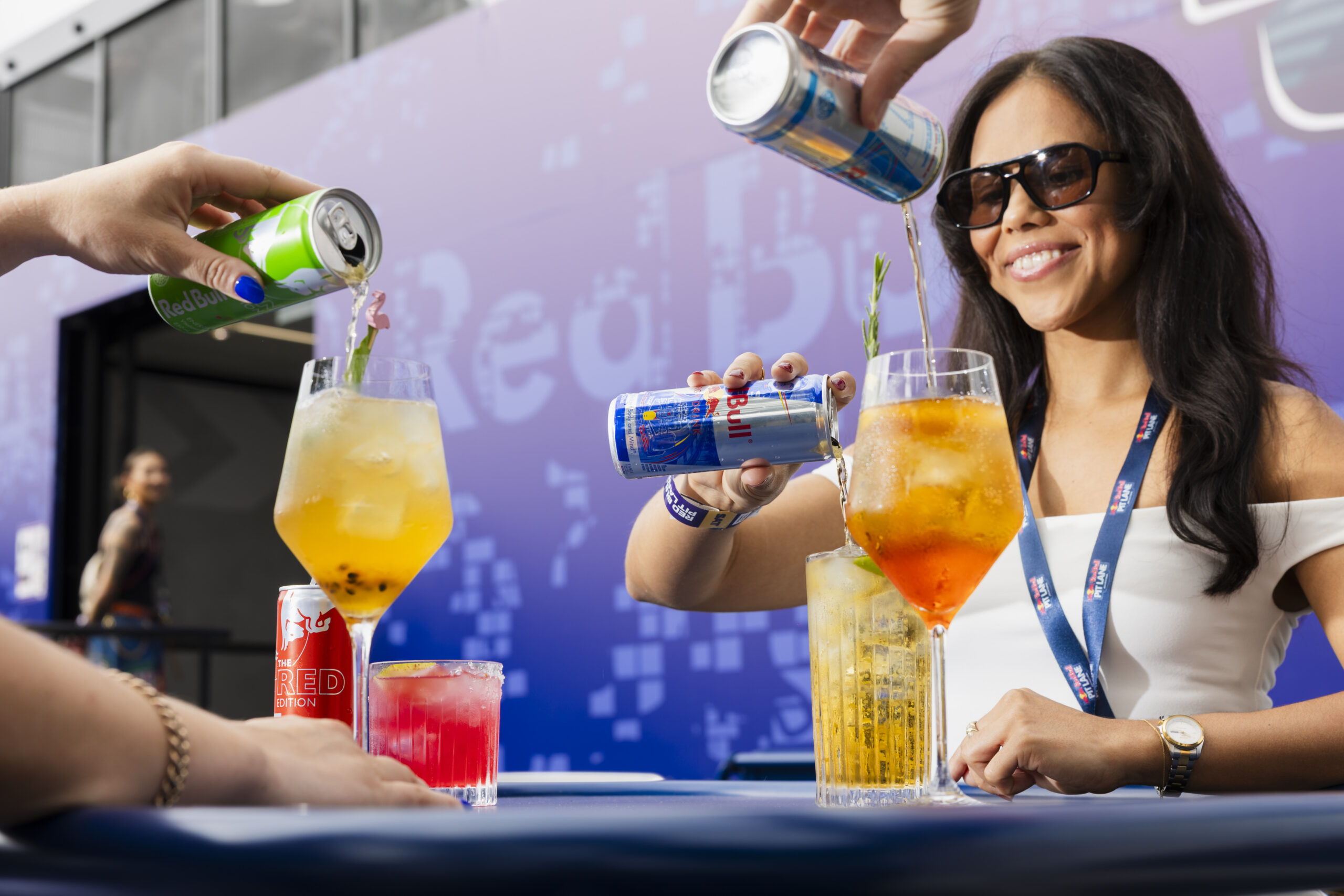 Pit Lane guests pouring Red Bull into cocktail glass for the perfect serve