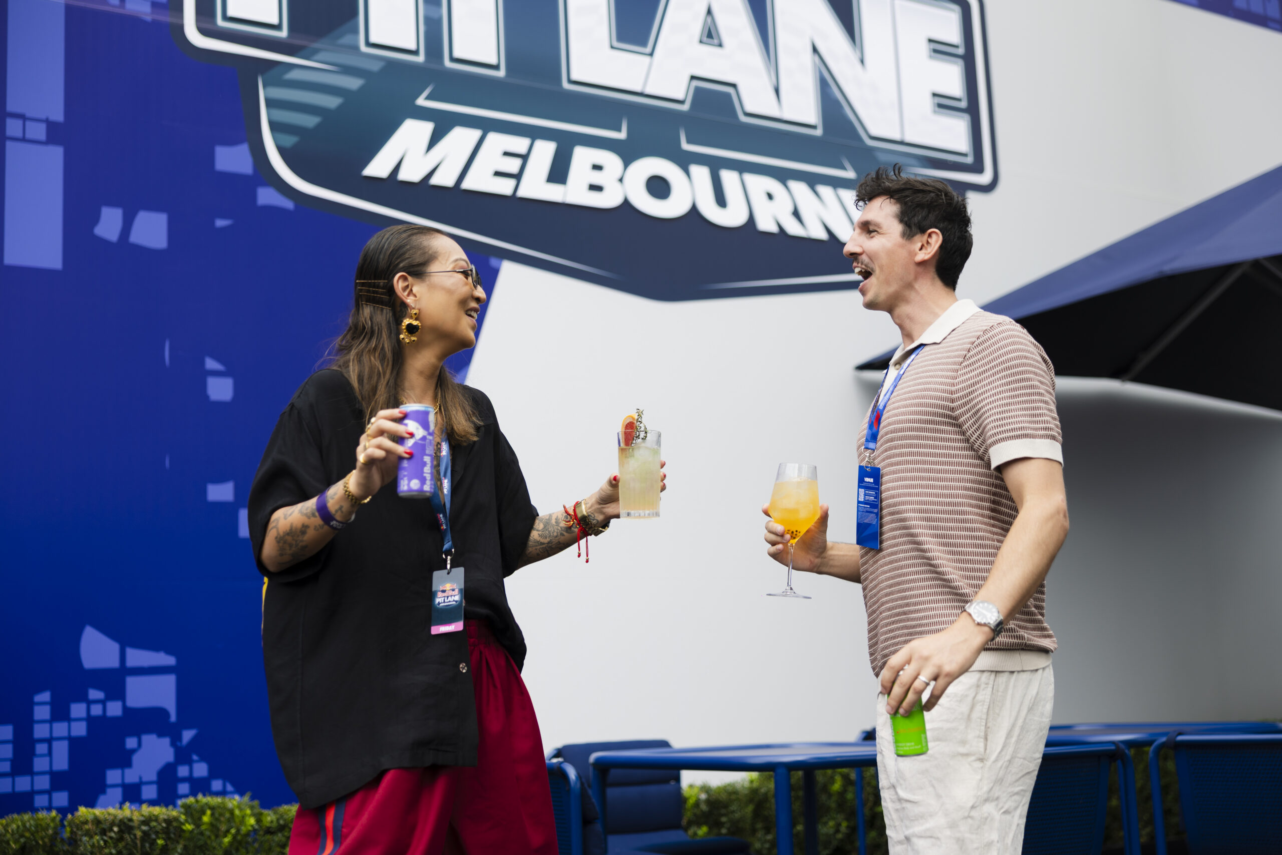 Man and woman drinking Red Bull cocktails