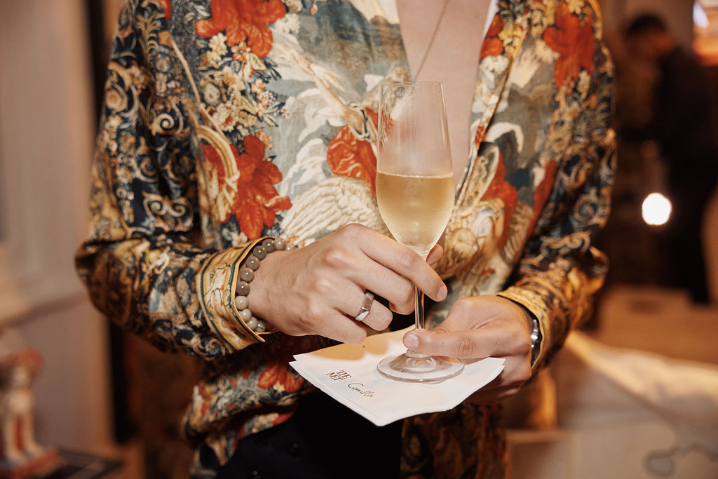 Guest drinking champagne with a branded napkin