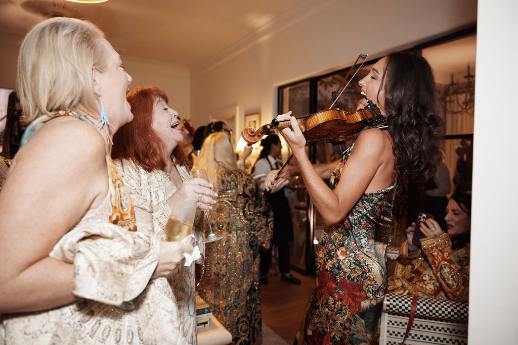Violinist playing music at Camilla x Met VIP party