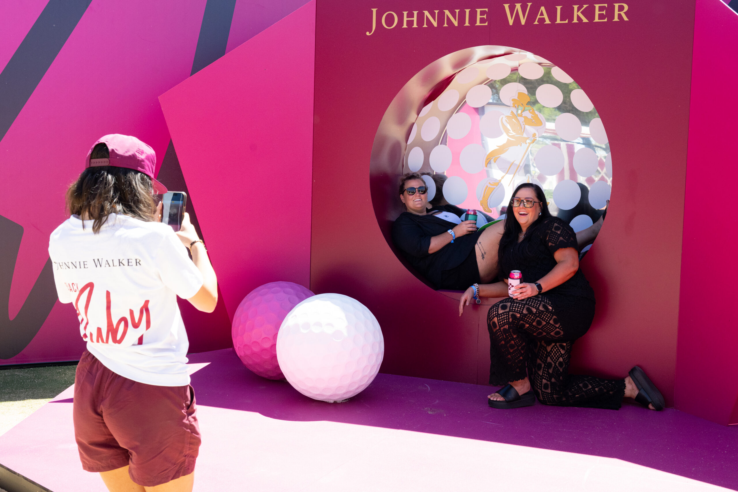 Women posing at Johnnie Walker photo moment